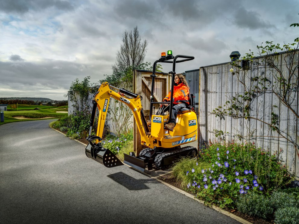 JCB 8008E micro excavator fitted with a bucket tracking through a narrow garden gate. 