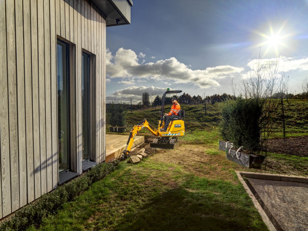 JCB 8008E micro excavator digging a trench for bushes to be planted into. 